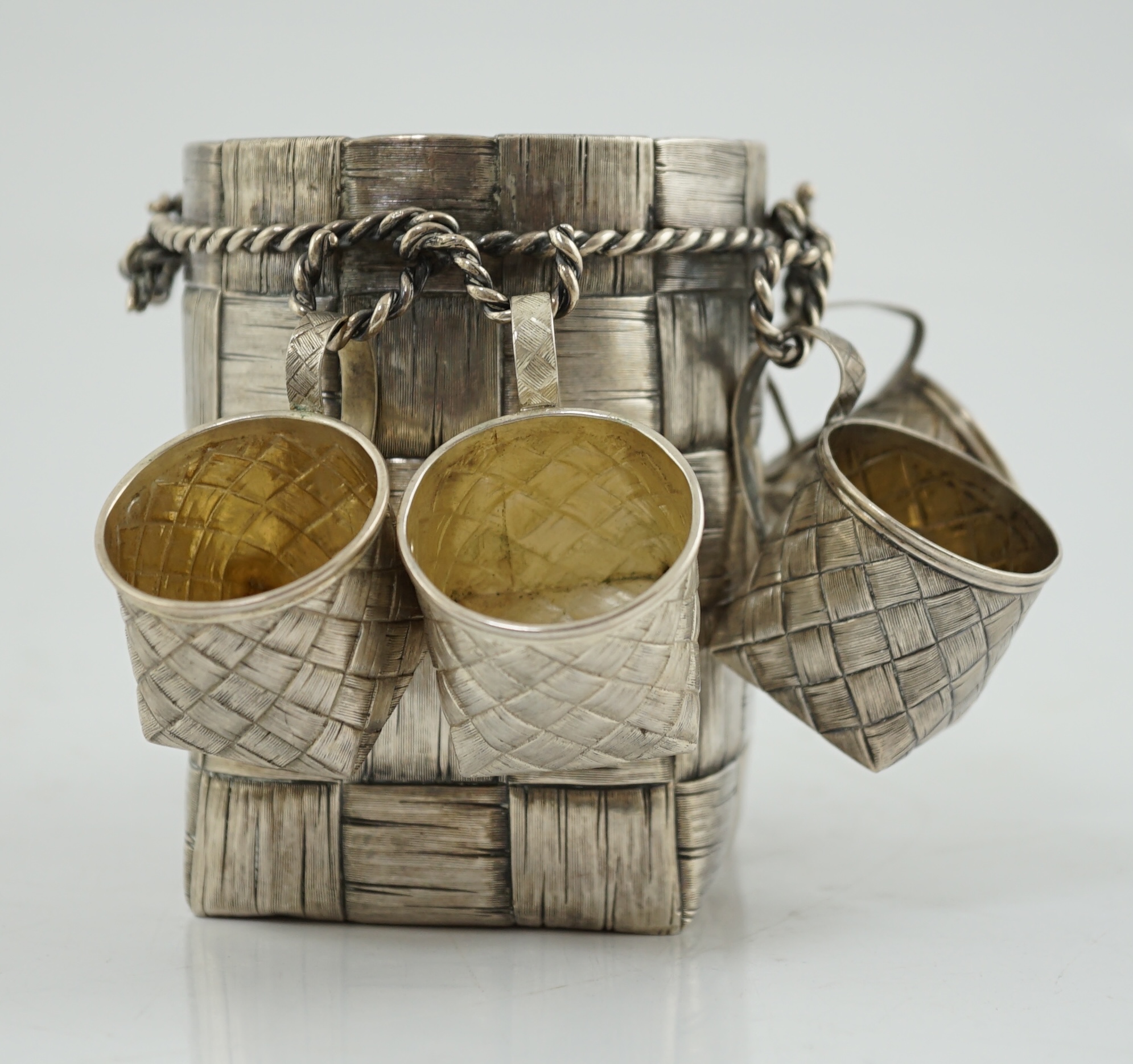 A late 19th century Russian 84 zolotnik silver bottle holder, with basket weave decoration, together with five similar tots